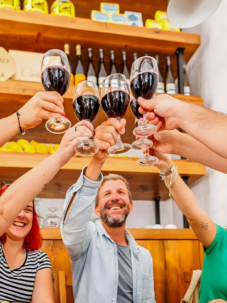 Tourists toasting with wine during Lisbon Food Walk in Baixa.