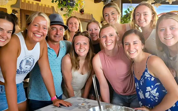 Group enjoying Amalfi Coast cooking class, learning to make tiramisù, mozzarella, and pasta.
