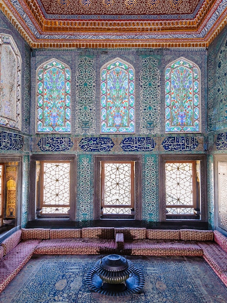 Topkapi Palace Harem section with intricate tilework and stained glass windows.