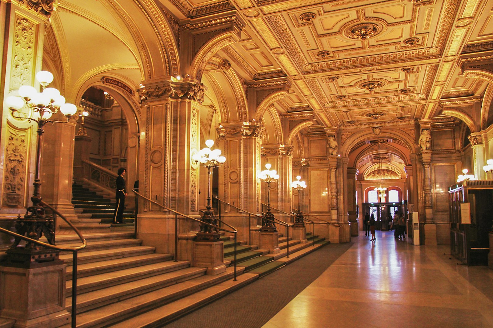 Vienna State Opera interior with ornate arches and grand staircase.