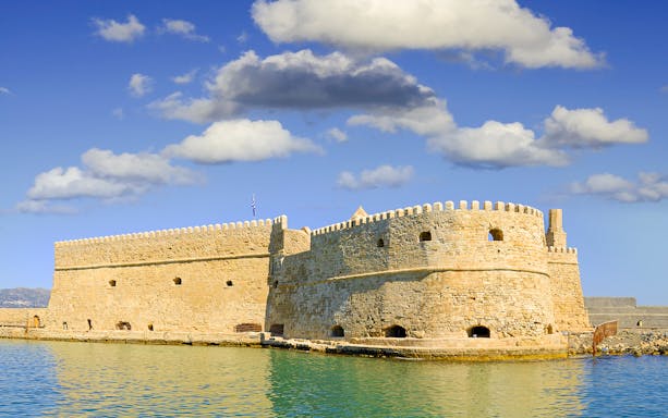 Heraklion Venetian Fortress on the waterfront under a blue sky.