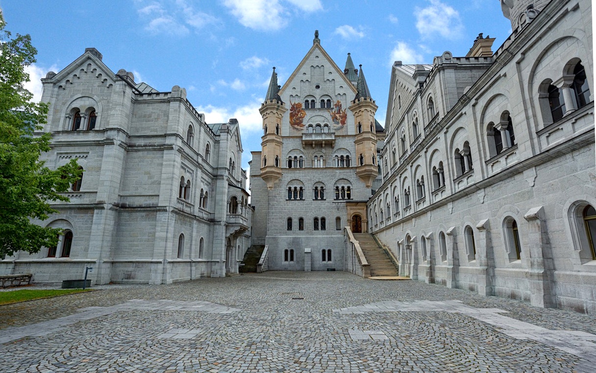 Neuschwanstein Castle courtyard with ornate architecture on a day trip from Munich.