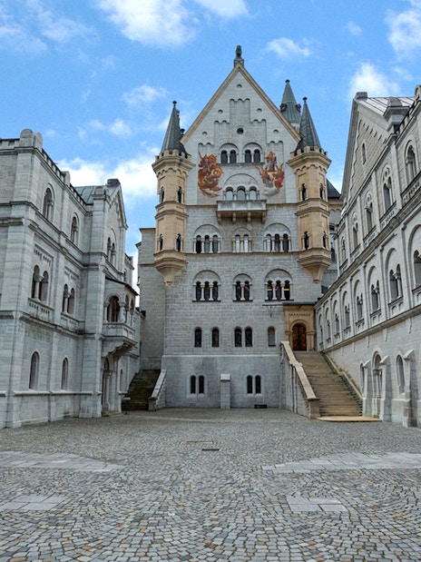 Neuschwanstein Castle courtyard with ornate architecture on a day trip from Munich.