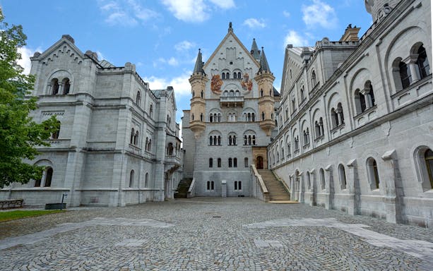 Neuschwanstein Castle courtyard with ornate architecture on a day trip from Munich.