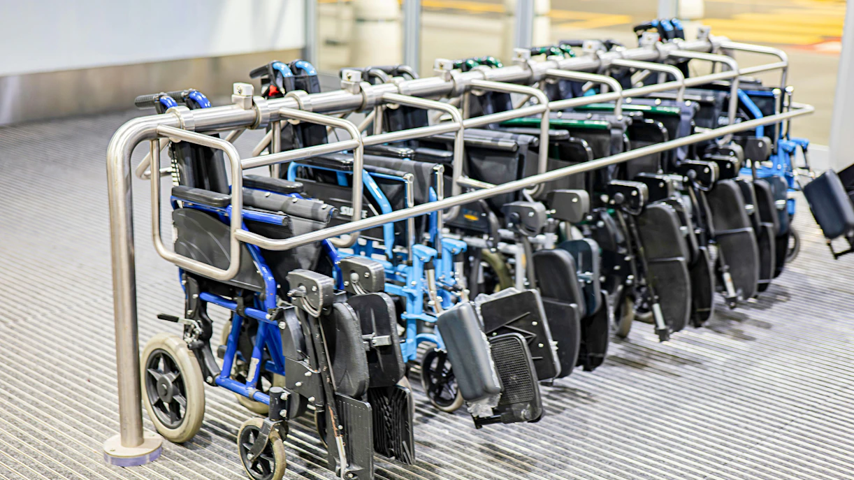 Wheelchairs lined up at an accessible facility entrance.