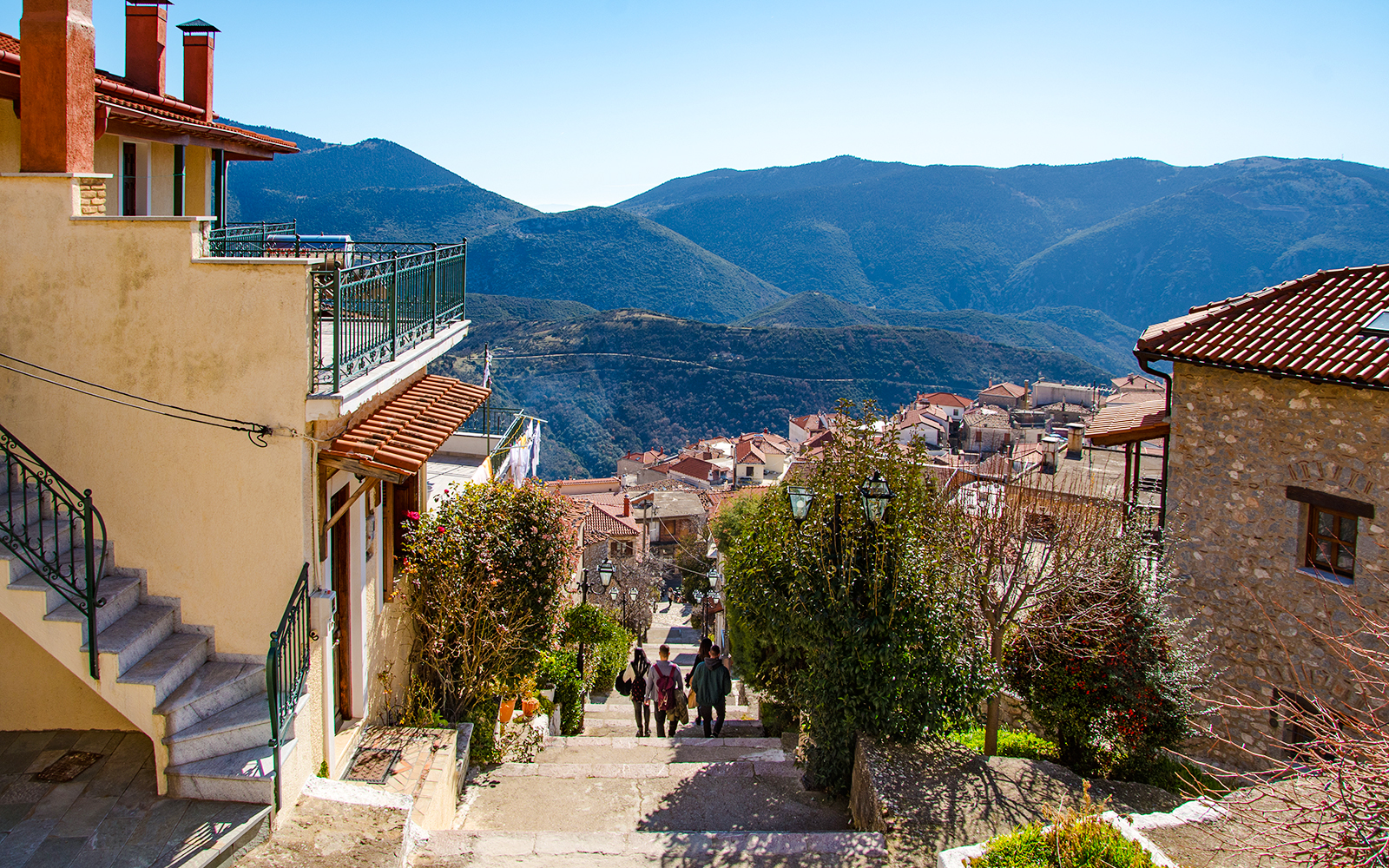 Arachova Village street with mountain views and traditional houses.