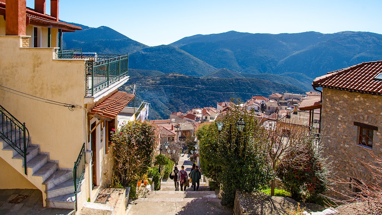 Arachova Village street with mountain views and traditional houses.