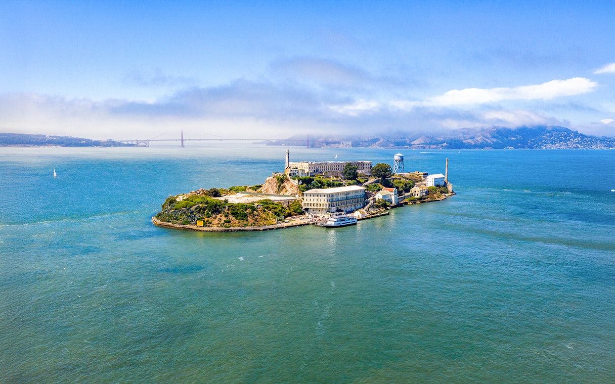 Aerial view of Alcatraz Island with San Francisco Bay in the background.