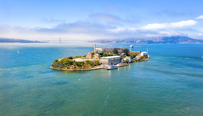 Aerial view of Alcatraz Island with San Francisco Bay in the background.