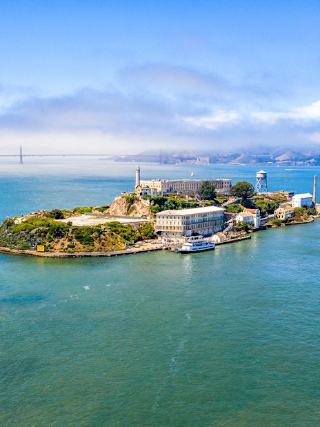 Aerial view of Alcatraz Island with San Francisco Bay in the background.