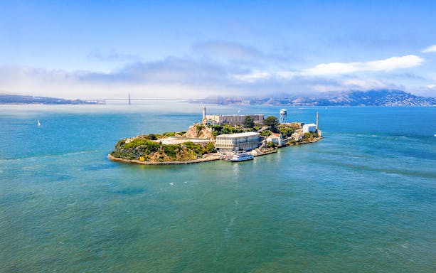 Aerial view of Alcatraz Island with San Francisco Bay in the background.