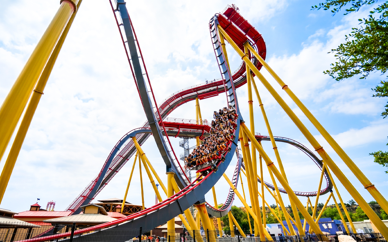 Roller coaster at Six Flags Fiesta Texas, Dr. Diabolical's Cliffhanger, with riders on steep drop.