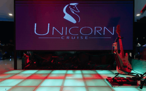 Unicorn Dinner Cruise stage with guitar setup in Bangkok.