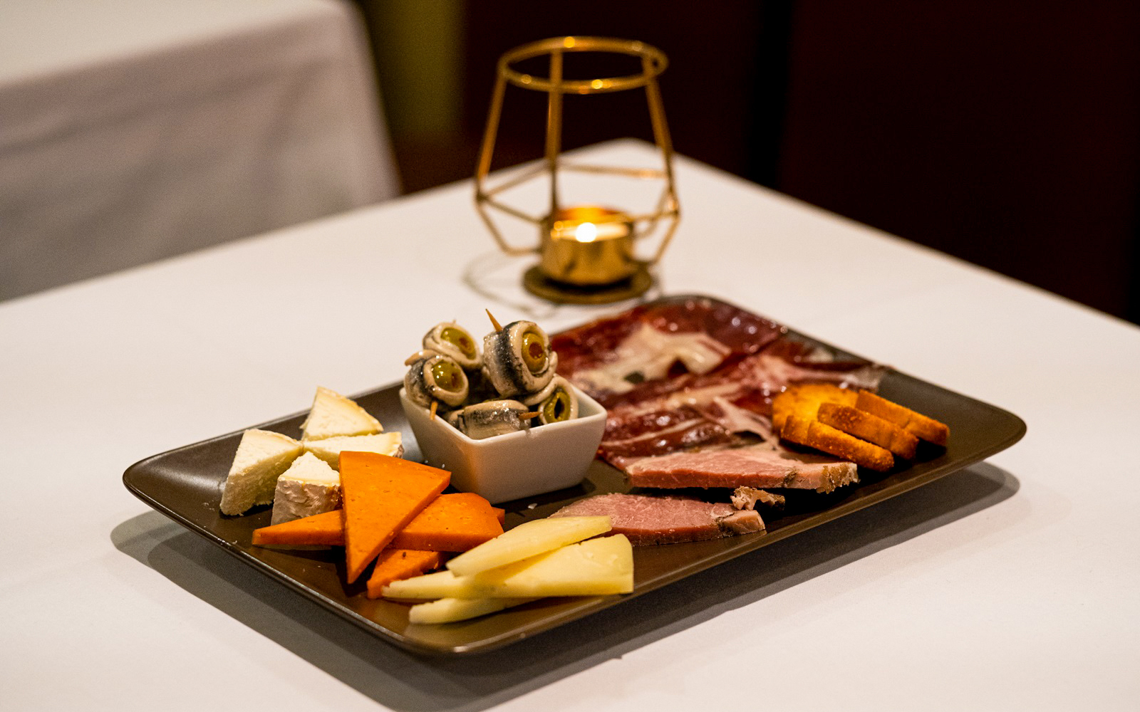 Spanish tapas platter with cheese, meats, and olives served at a Pure Flamenco Show.