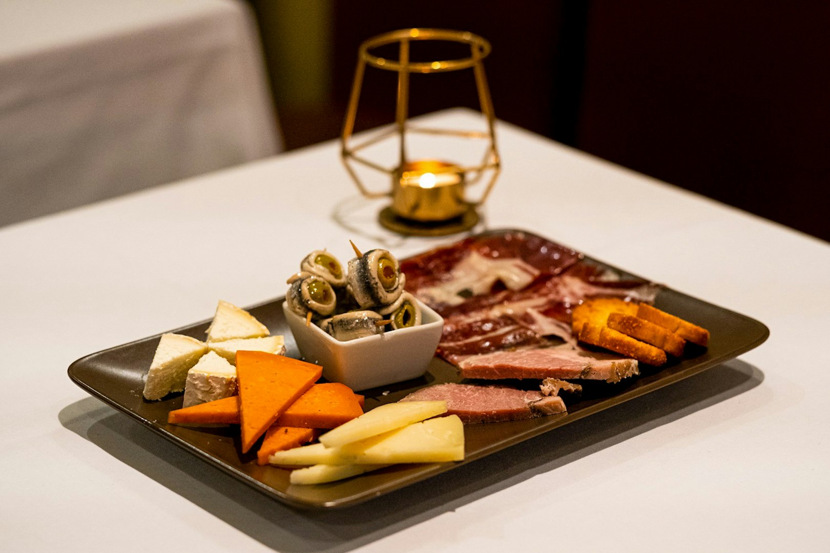 Spanish tapas platter with cheese, meats, and olives served at a Pure Flamenco Show.