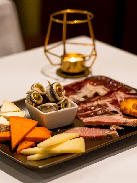 Spanish tapas platter with cheese, meats, and olives served at a Pure Flamenco Show.