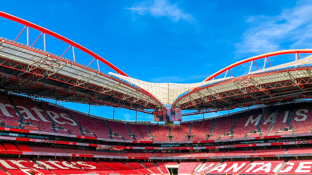 Benfica Stadium ground view with lush green field and surrounding stands in Lisbon, Portugal.