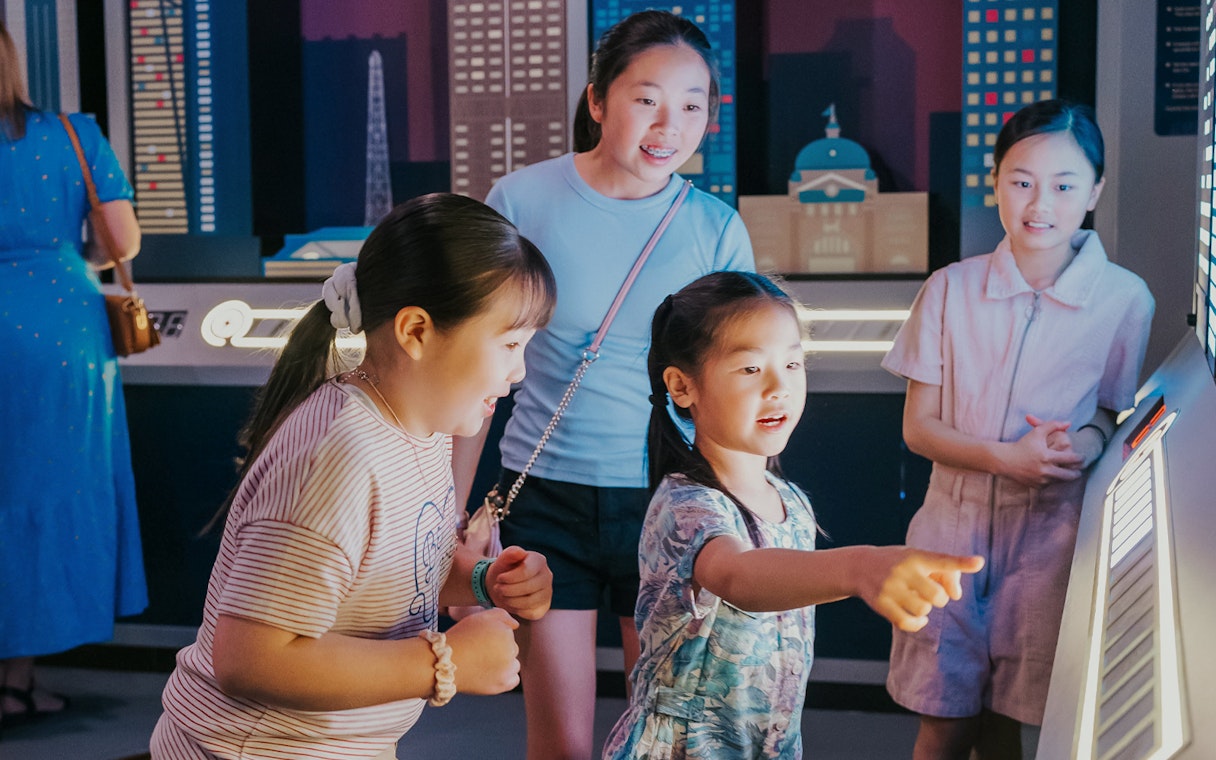 Children interacting with an electric piano at Monopoly Dreams Melbourne.