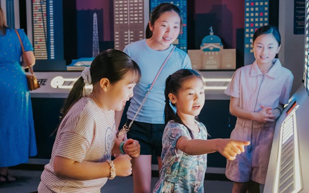 Children interacting with an electric piano at Monopoly Dreams Melbourne.