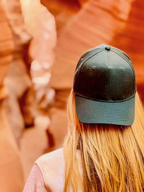 Visitor exploring the narrow sandstone walls of Lower Antelope Canyon.