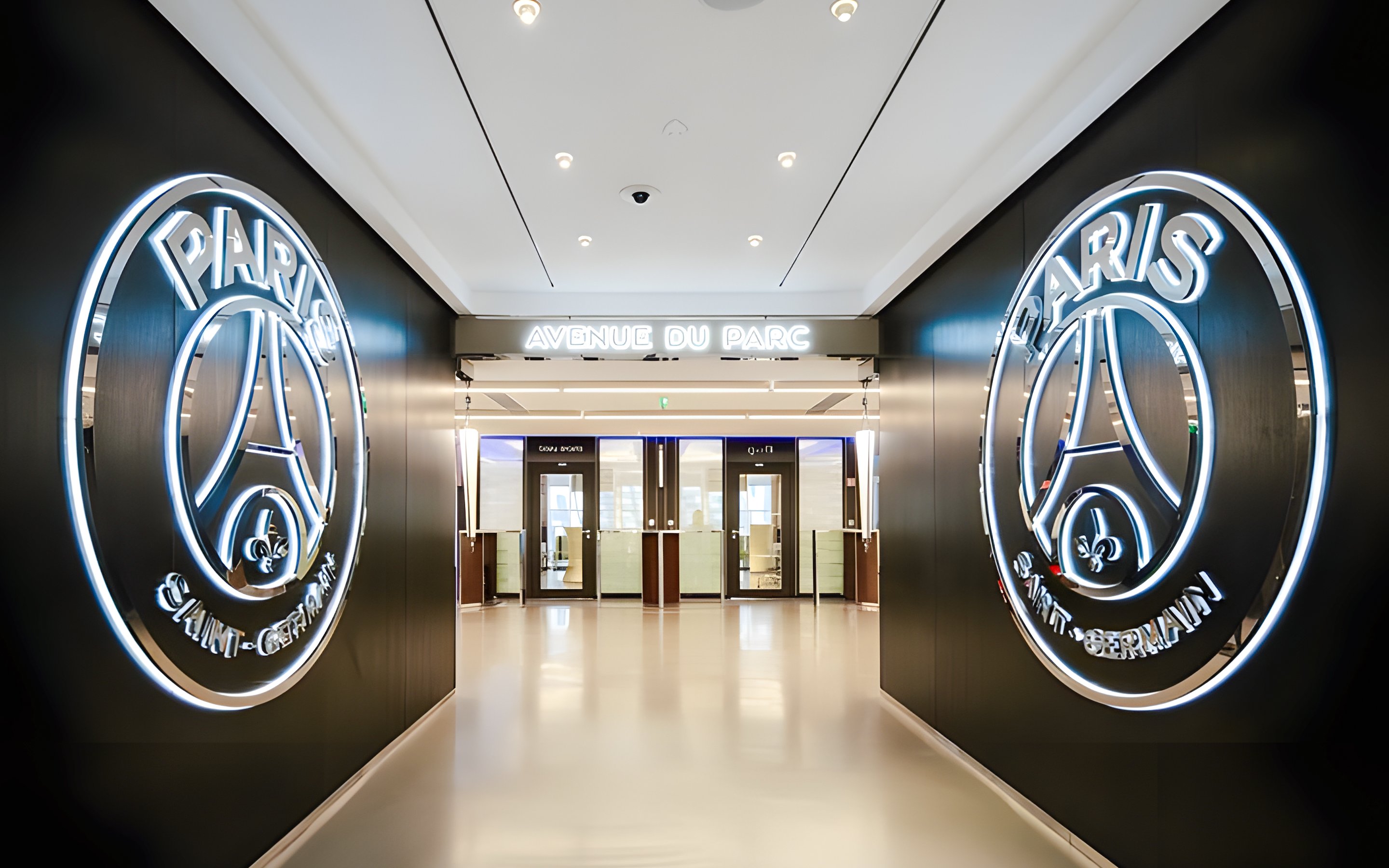 PSG Stadium entrance hallway with illuminated Paris Saint-Germain logos, Paris, France.