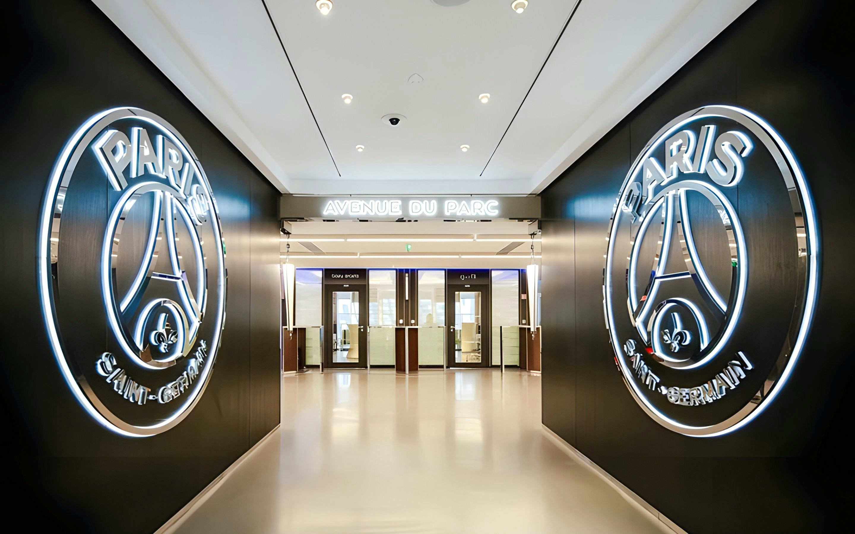 PSG Stadium entrance hallway with illuminated Paris Saint-Germain logos, Paris, France.