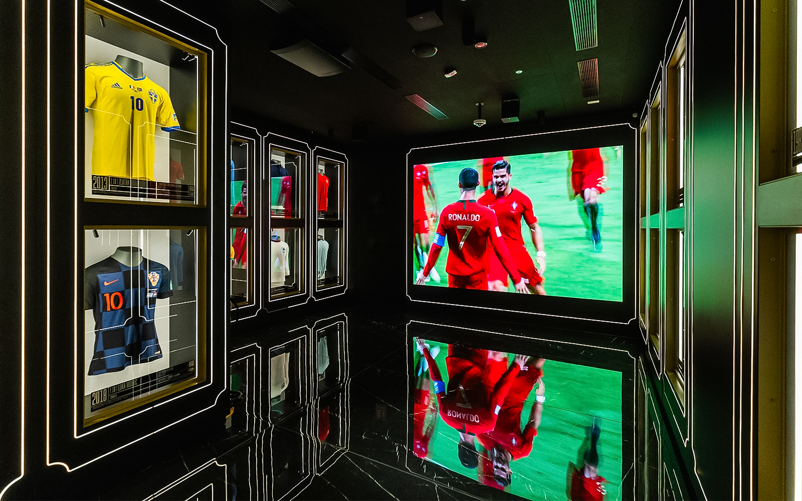 Football memorabilia display at Legends: The Home of Football Museum, featuring iconic jerseys and trophies.