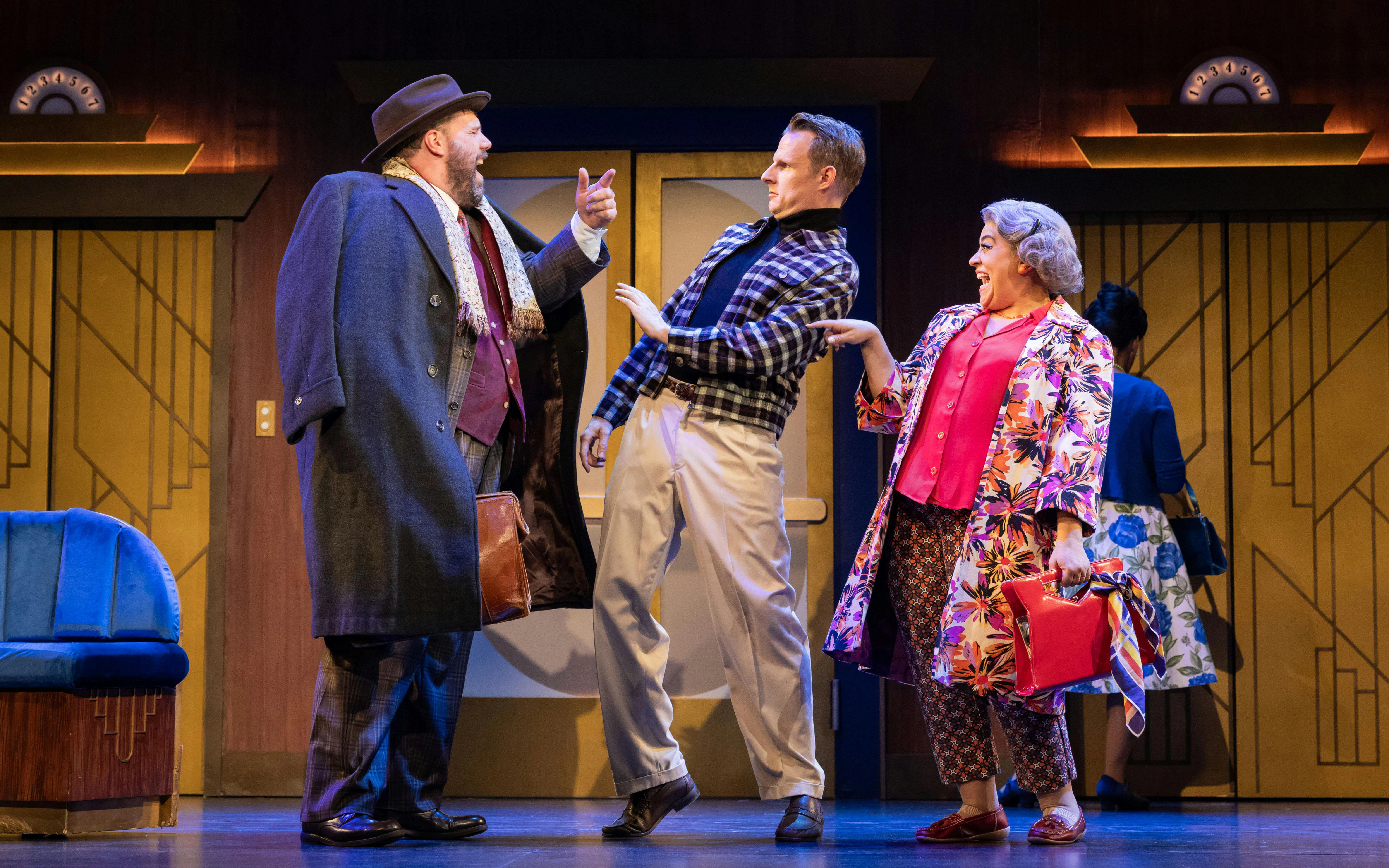 Actors performing a comedic scene in "The Comedy About Spies" on stage.
