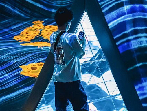 Person exploring digital art installation at Teamlab Forest Fukuoka.