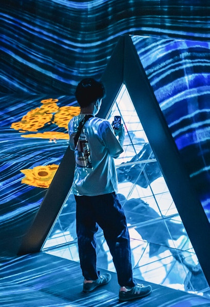 Person exploring digital art installation at Teamlab Forest Fukuoka.