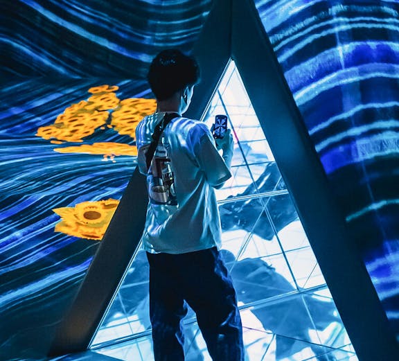 Person exploring digital art installation at Teamlab Forest Fukuoka.