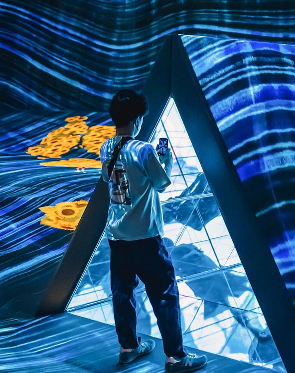 Person exploring digital art installation at Teamlab Forest Fukuoka.