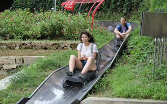 Visitors enjoying a toboggan ride at Mutianyu Great Wall, China.