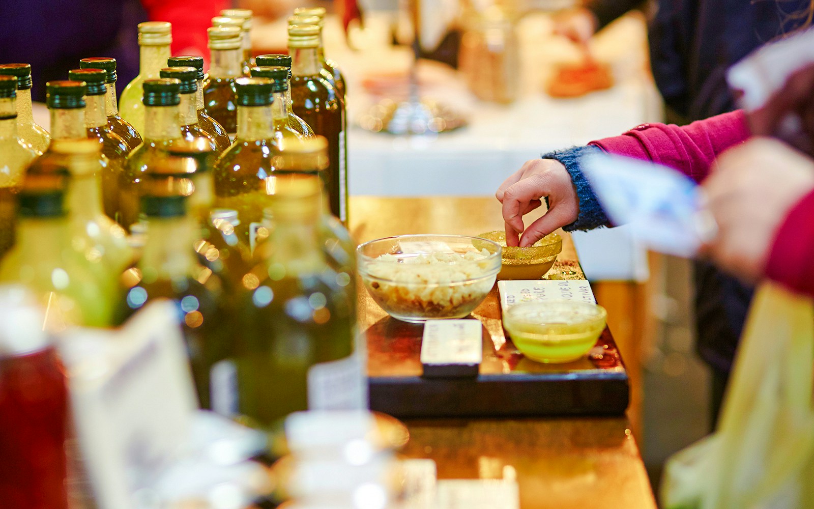 Tasting olive oils at a market in greece.