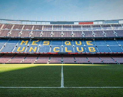Camp Nou stadium seating with "Més Que Un Club" slogan, Barcelona.