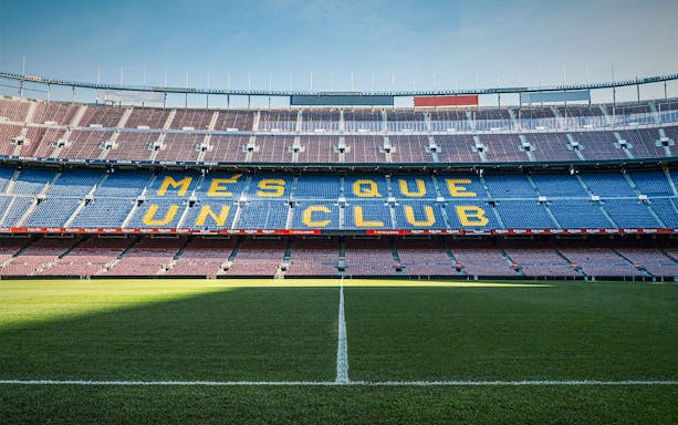 Camp Nou stadium seating with "Més Que Un Club" slogan, Barcelona.