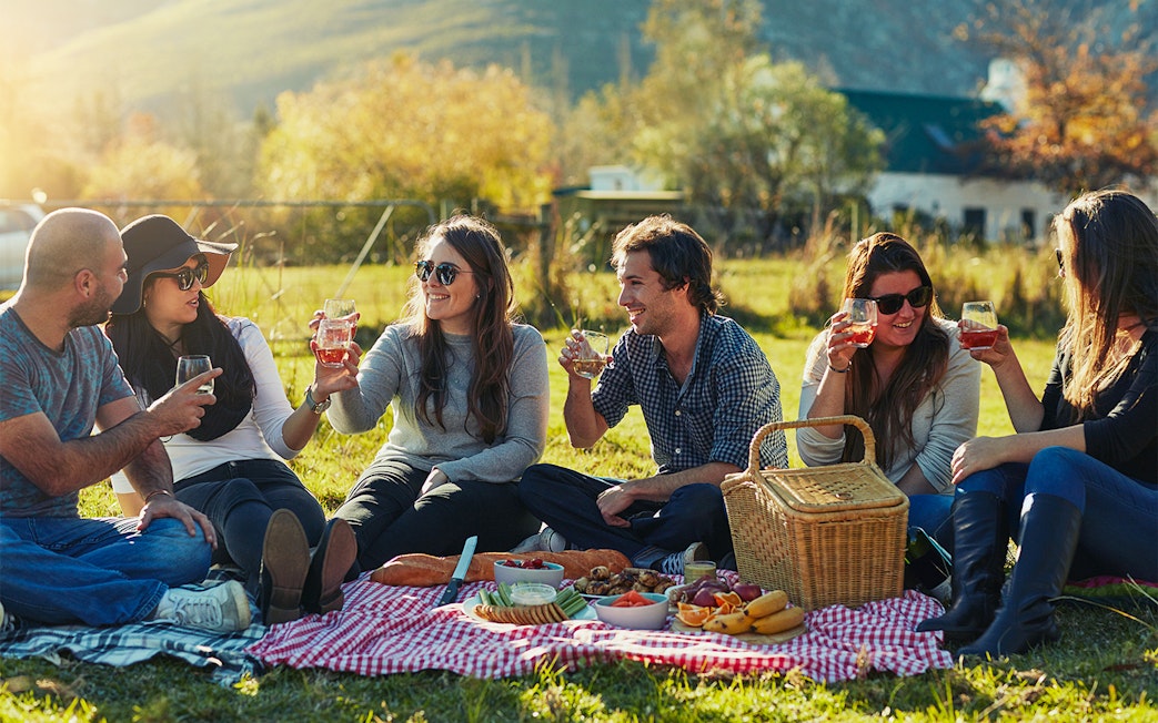 Group enjoying picnic lunch with drinks at Loch Ness.
