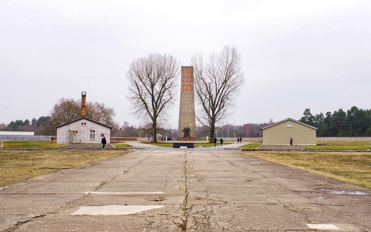 Sachsenhausen Concentration Camp memorial with central obelisk and surrounding buildings.