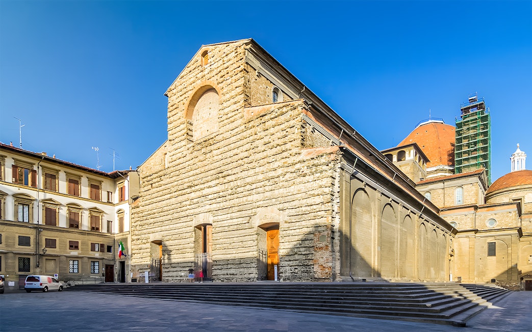 San Lorenzo Church exterior in Florence, Italy, showcasing its stone facade and architectural details.