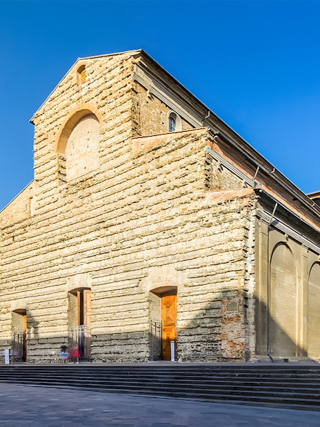 San Lorenzo Church exterior in Florence, Italy, showcasing its stone facade and architectural details.