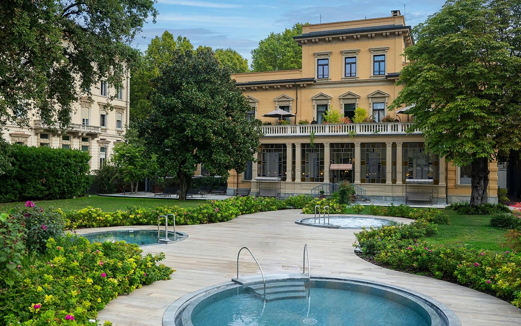 Outdoor spa pools and garden at QC Terme Torino, Italy.