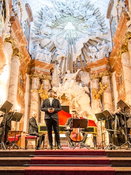 Tourists exploring a historic street with colorful buildings in Kyiv, Ukraine.