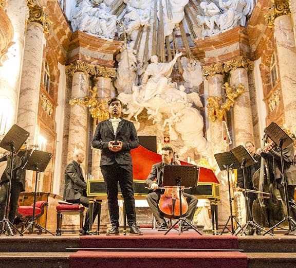 Tourists exploring a historic street with colorful buildings in Kyiv, Ukraine.
