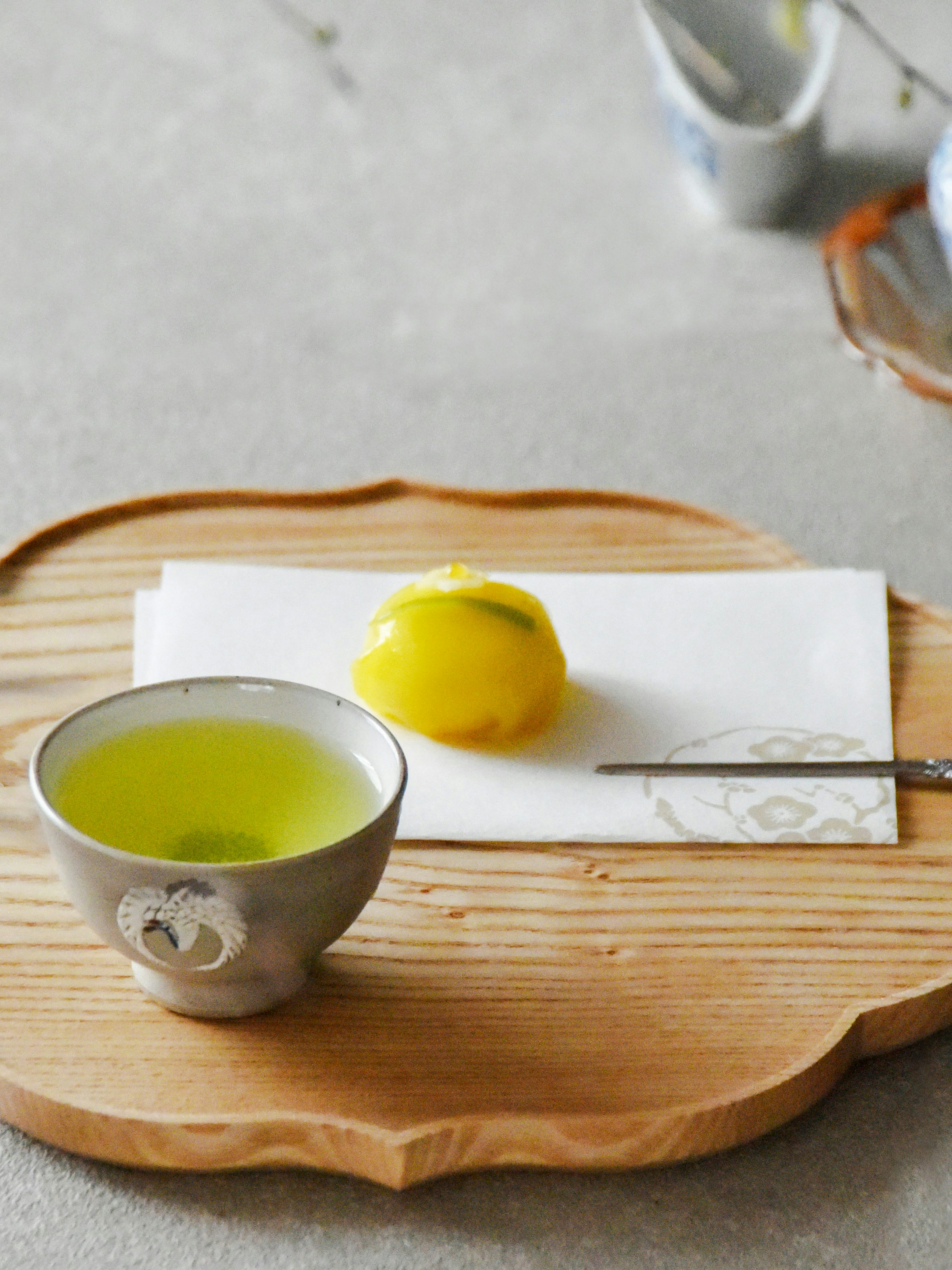 Wagashi sweet with matcha tea on a wooden tray, Japan.