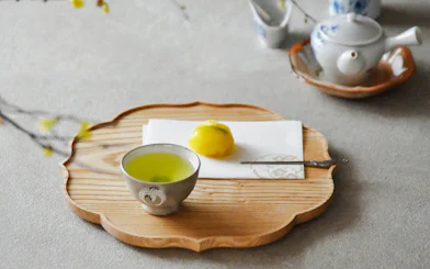 Wagashi sweet with matcha tea on a wooden tray, Japan.