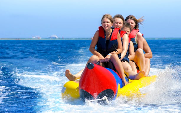 Group enjoying banana boat ride on Dolphin Watching Cruise from Hurghada.