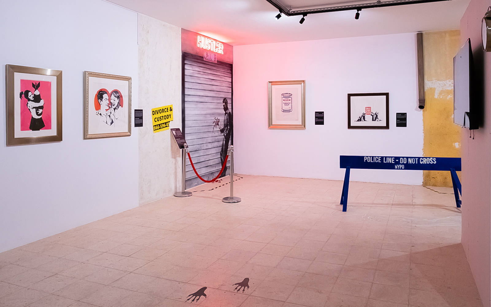 Banksy Museum exhibit in Lisbon featuring street art and installations.