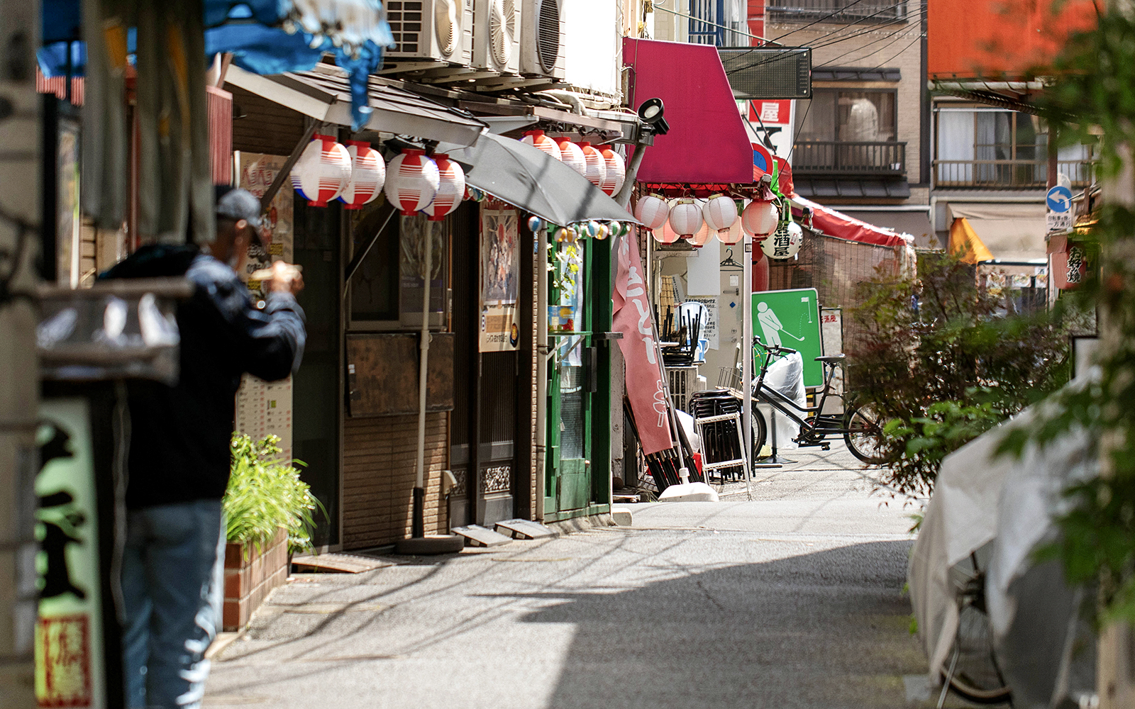 Narrow street in Asakusa with traditional lanterns and shops, part of Senso-ji Temple audio tour.