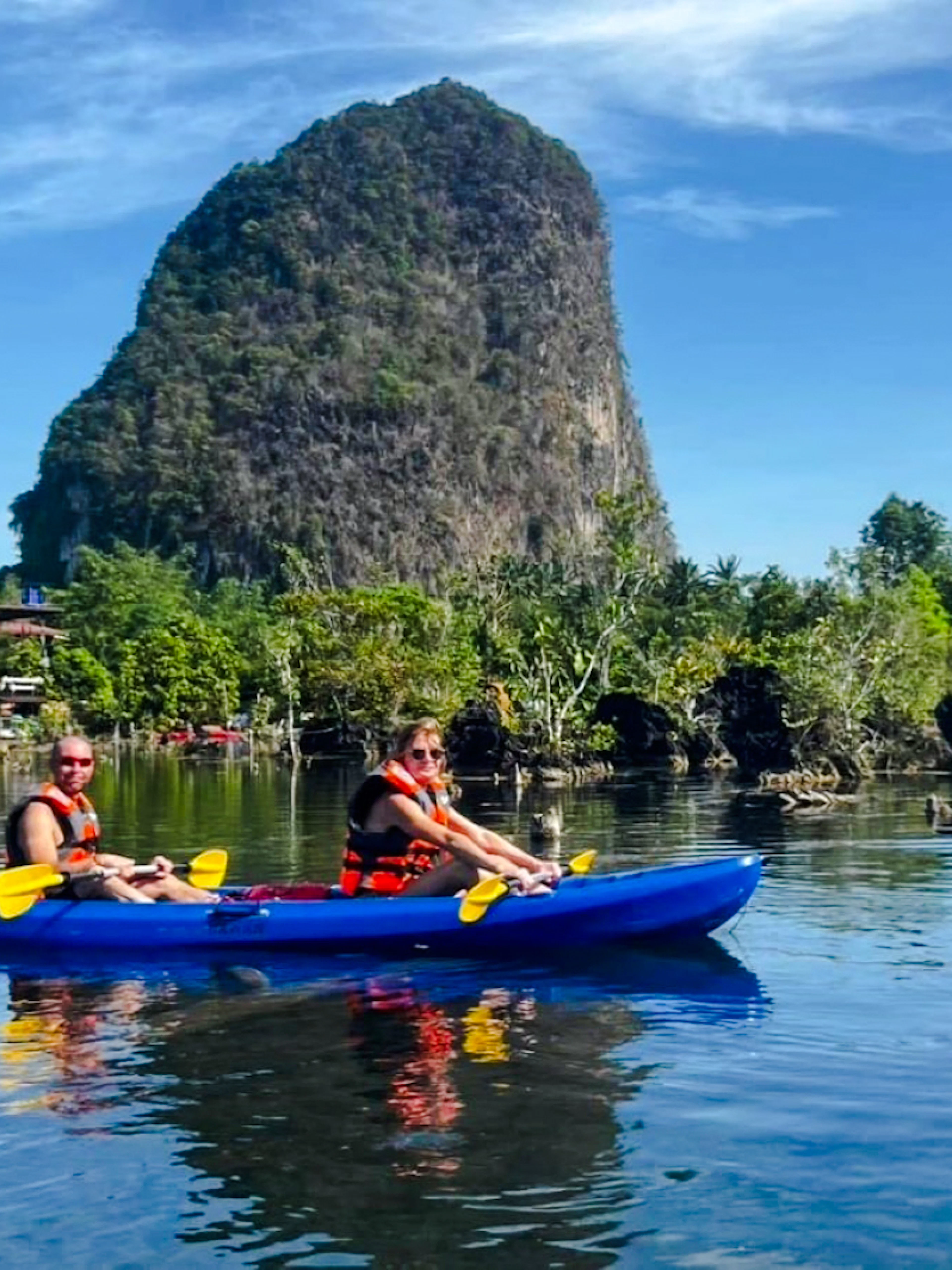 Kayaking on Klong Root with limestone cliffs in Krabi, Thailand.