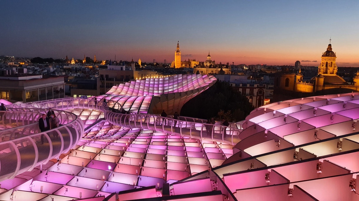 Visitors walking on illuminated Setas de Sevilla at night, Seville, Spain.